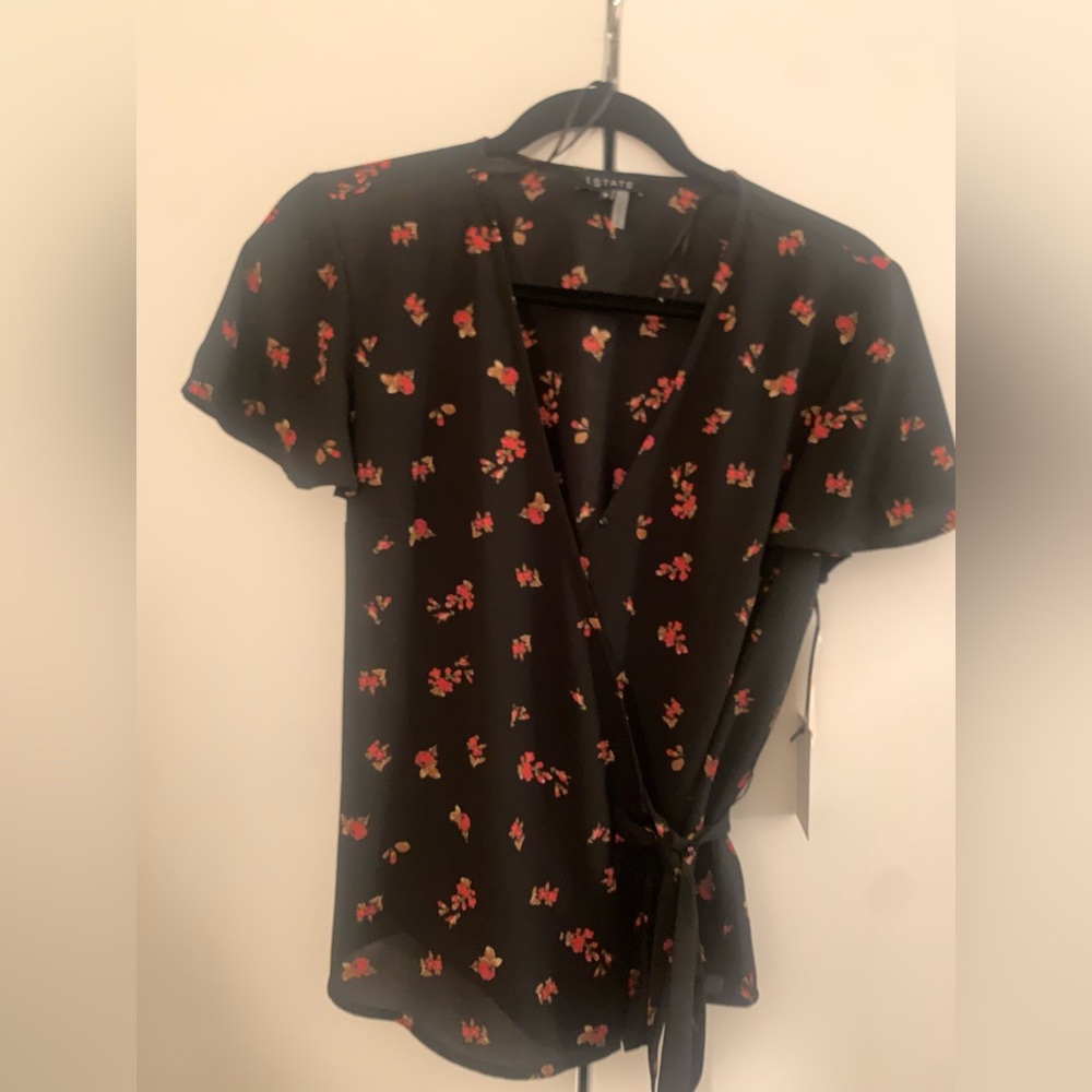Never worn, tags on, short sleeve wrap floral shirt.